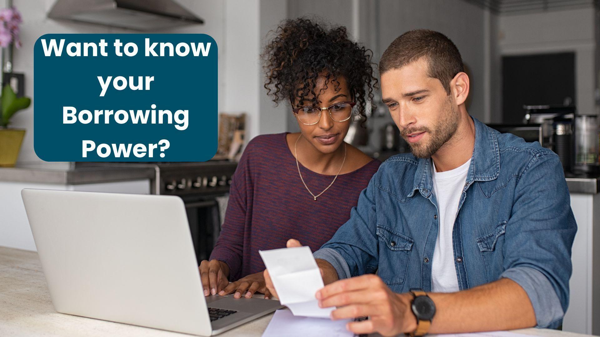 A couple sitting in front of a laptop in their kitchen working our their home loan borrowing power